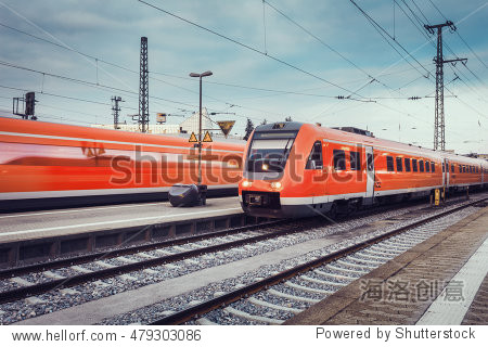 modern high speed red passenger commuter trains at the railway