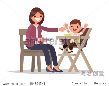 child feeding. mother feeds the baby sitting in the highchair.