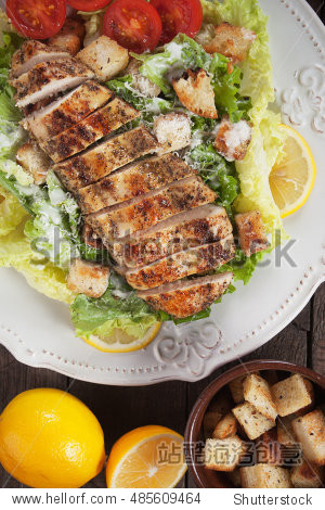 grilled chicken steak served over caesar salad - 站酷海洛正版