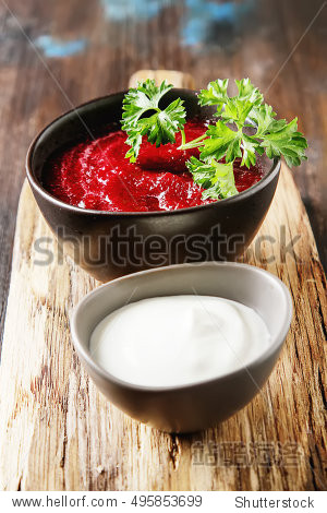 traditional beetroot soup in a brown plate with temyan, sour