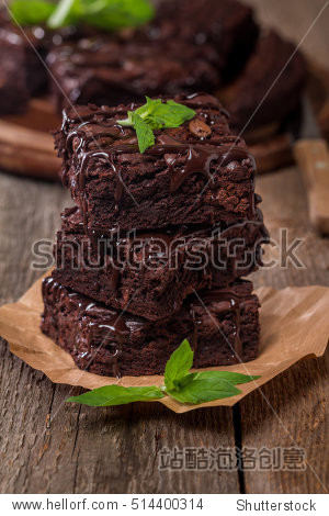 delicious chocolate brownie with mint on wooden table.