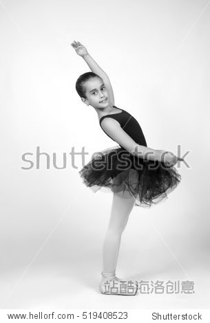 little young ballerina girl ballerina dancing on a white back