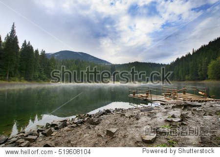 mountain lake synevir landscape with a mist low on water, two