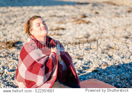 young plus size woman resting on the beach. sport concept.