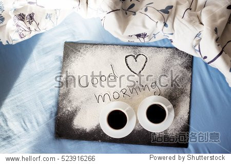 goodmorninginscriptionflouronaboardwithcupsofcoffeeheart