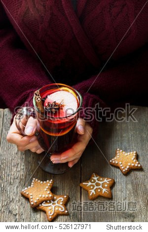 christmas hot drink - mulled wine in female hands with cinnamon