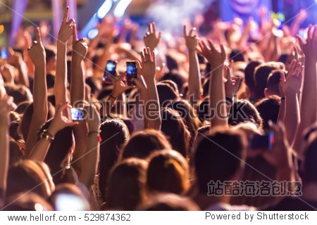 hand with a smartphone records live music festival, taking photo