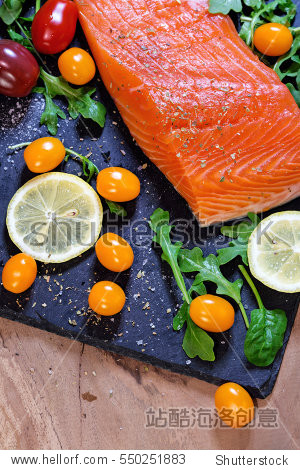 fresh raw salmon fillet with aromatic herbs spices