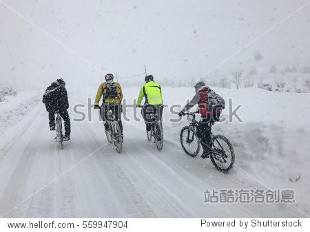 adventurous bikers in snowy weather