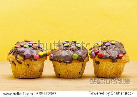 fresh chocolate chip muffin with colorful chocolate bonbons