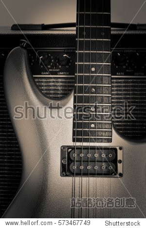 electric guitar propped up against a guitar amplifier.