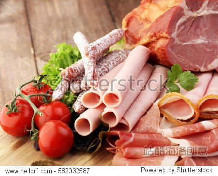 food tray with delicious salami, pieces of sliced ham, sausage
