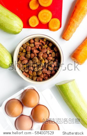 set of animal dry food, vegetables and eggs on kitchen top view