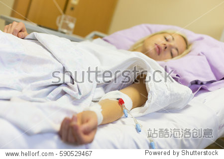 bedridden female patient lying in hospital bed, receive infusion