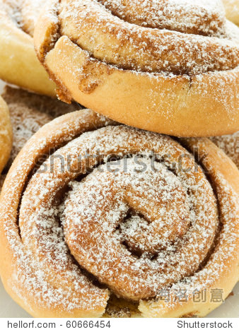 sweet buns with cinnamon and powdered sugar. shallow dof.