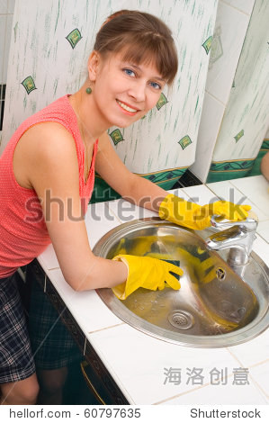 the woman washes a bowl; cleaning in a bathroo