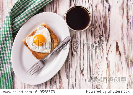 fried egg in the form of heart with toast on a plate