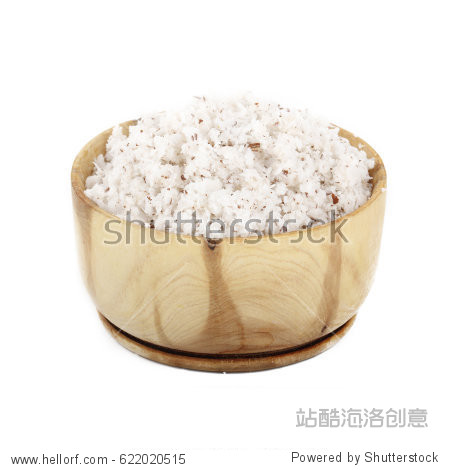 dried grated coconut in wooden cup isolated on white background