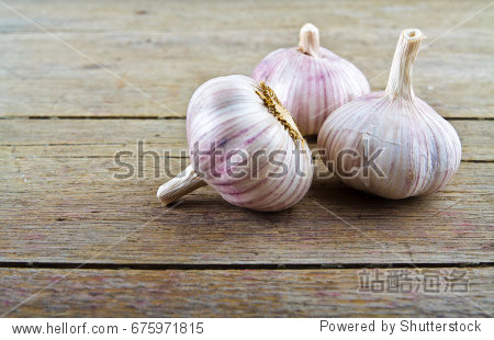 pungent garlic on wooden background