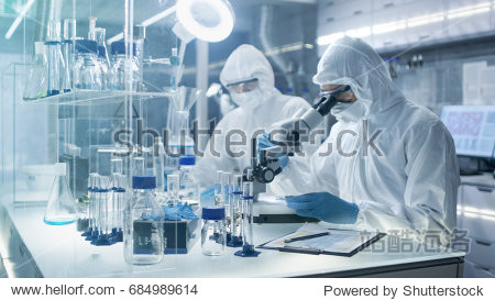 chemist adjusts samples in a petri dish with