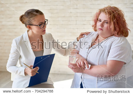 portrait of beautiful young woman comforting crying obese woman 