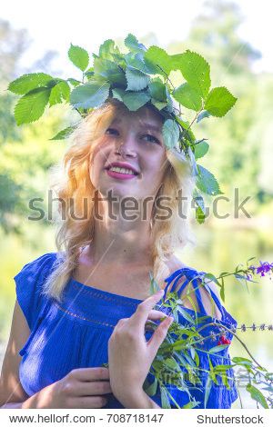 the girl with the wreath . on the background of nature