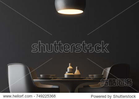 Black wall minimalistic dining room interior with a round black table and black chairs standing near it. A ceiling lamp. 3d rendering mock up