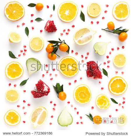 sliced orange lemon pomegranate tangerine green leaves isolated