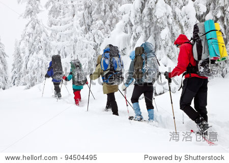 team of hikers in winter mountains