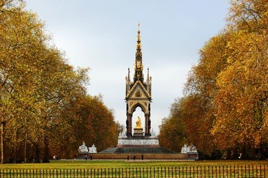 the albert memorial surrounded by beautiful golden autumn trees. london, uk
