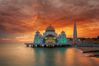 malacca mosque on the beach in melaka city with sunset in malaysia