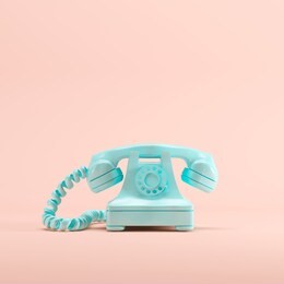 blue vintage telephone on pink pastel color background. minimal idea concept.