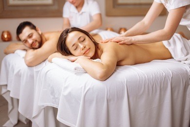 happy caucasian couple enjoying a back massage.