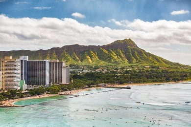 hawaii vacation travel aerial view of waikiki beach and honolulu city with diamond head mountain in background. urban landscape for usa travel summer vacation destination.