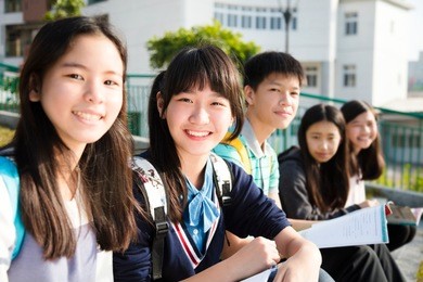 group of teenage students study in school