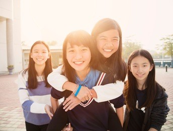 group of teenage students playing in school
