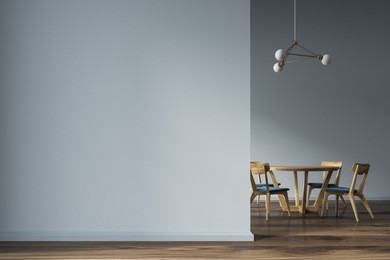 minimalistic gray dining room interior with a wooden floor, and a round wooden table with wooden and blue chairs. a blank wall fragment. 3d rendering mock up