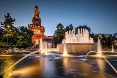 sforza castle (castello sforzesco) with the beautiful fountain at night, milan, italy. this castle was built in the 15th century by sforza, duke of milan. it is one of the main landmarks of milan.
