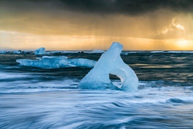 icebergs on the beach of jökulsárlón glacier lagoon in south-east iceland. they roll around in the waves where they gradually melt and disappear.