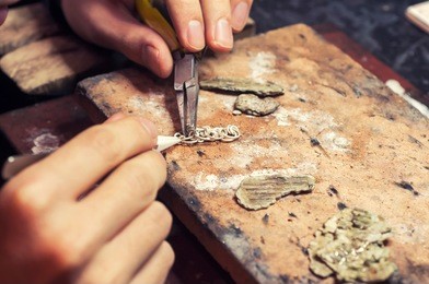 jeweler produces gold jewelry in the workshop