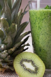 pineapple kiwi green healthy drink smooties in glass on the table