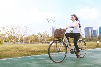 beauty asian woman in white shirt and bicycle in park