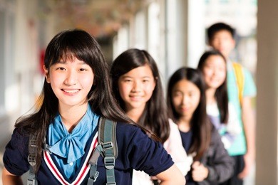 group of teenage studentsÂ standing before classroom