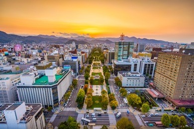 sapporo, japan cityscape over odori park at dusk.
