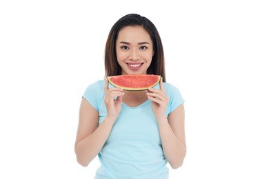pretty dark-haired woman posing for photography with charming smile while holding slice of watermelon in hands, isolated on white background