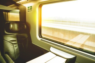 traveling by train: look out the window at a moving landscape at sunset