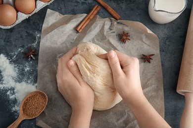 woman kneading dough on table, closeup
