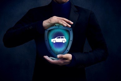 car insurance company safe and supporting customer concept, automobile icon inside a shield guard protected and careful gesture hands of businessman