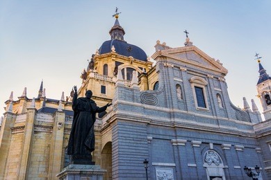 madrid, spain catedral de santa maría la real de la almudena facade.
external view of cathedral of saint mary the royal of la almudena roman catholic church next to the royal palace of madrid.