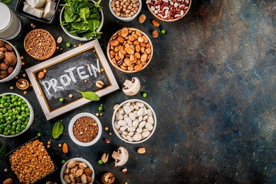 healthy diet vegan food, veggie protein sources: tofu, vegan milk, beans, lentils, nuts, soy milk, spinach and seeds. top view on white table.